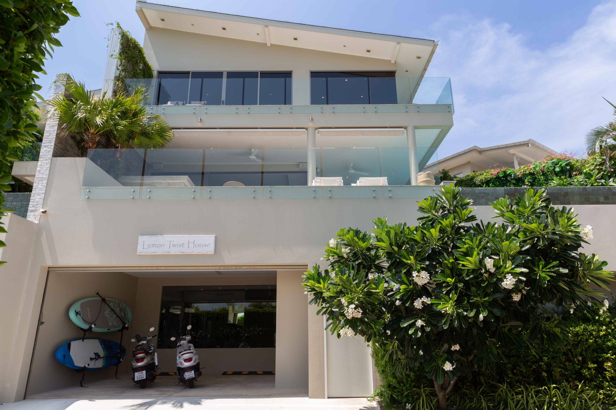 Front exterior view of Lemon Twist House with open garage